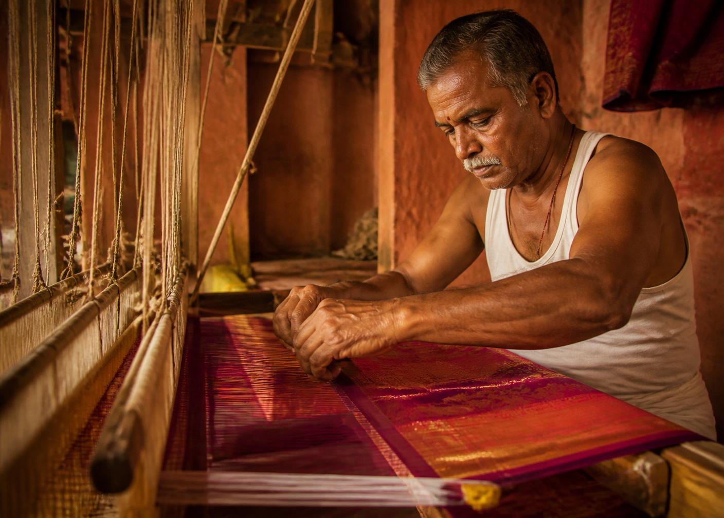 A weaver at a traditional handloom weaving silk saree